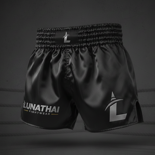 Black Muay Thai shorts with 'Lunathai Fightwear' branding on a dark background